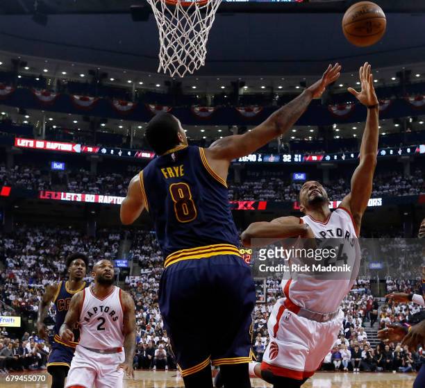 Toronto Raptors guard Norman Powell lets it fly to the rim over Cleveland Cavaliers forward Channing Frye . Toronto Raptors vs Cleveland Cavaliers in...