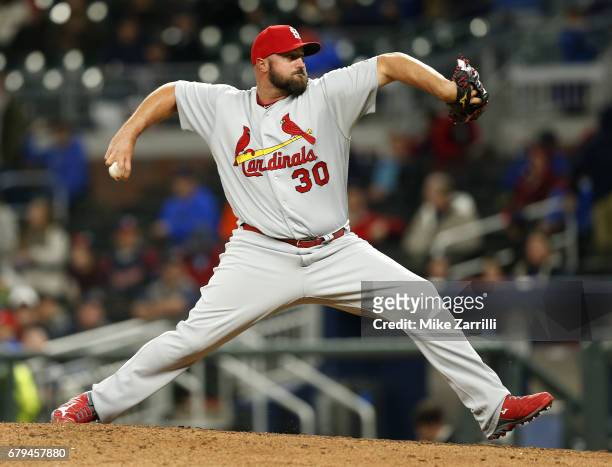 Pitcher Jonathan Broxton of the St. Louis Cardinals throws a pitch in the eighth inning during the game against the Atlanta Braves at SunTrust Park...