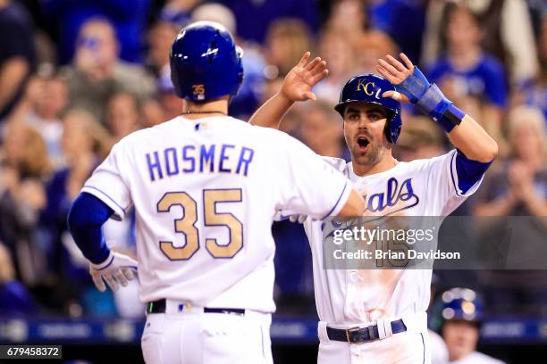 Whit Merrifield of the Kansas City Royals celebrates with Eric Hosmer of the Kansas City Royals after scoring on a Hosmer two-run home run against...