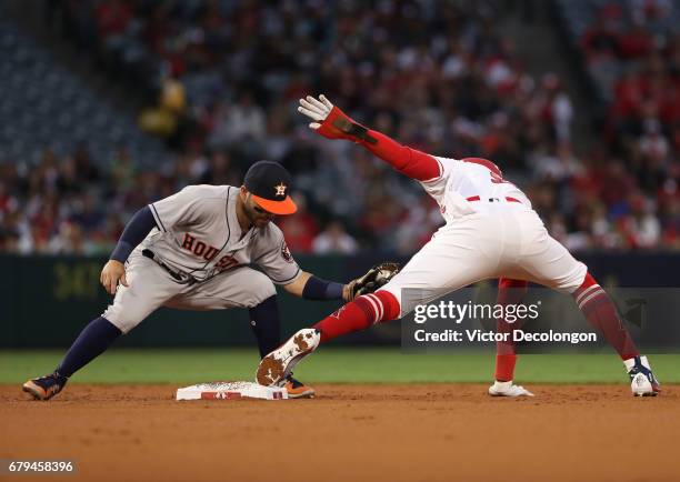 Jose Altuve of the Houston Astros holds the tag on Cameron Maybin of the Los Angeles Angels of Anaheim on the steal attempt at second base during the...