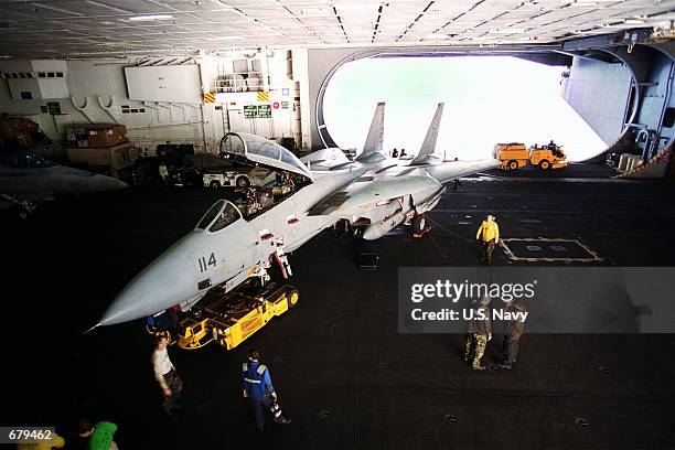 An F-14 "Tomcat" is parked for maintenance in a hangar bay November 3, 2001 on board the aircraft carrier USS Theodore Roosevelt. The Theodore...