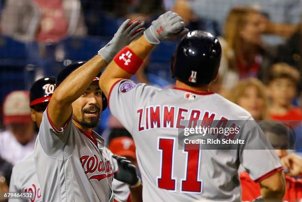 Ryan Zimmerman of the Washington Nationals is congratulated by Anthony Rendon after he hit a home run against the Philadelphia Phillies during the...