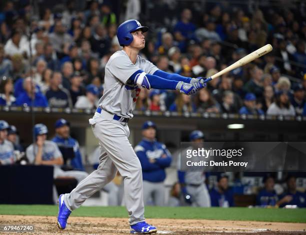 Cody Bellinger of the Los Angeles Dodgers hits a solo home run during the fourth inning of a baseball game against the San Diego Padres at PETCO Park...