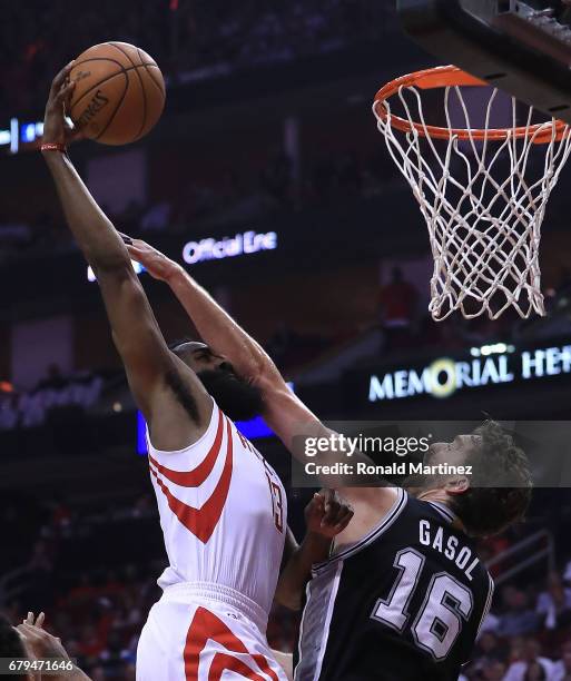 James Harden of the Houston Rockets dunks against Pau Gasol of the San Antonio Spurs during Game Three of the NBA Western Conference Semi-Finals at...