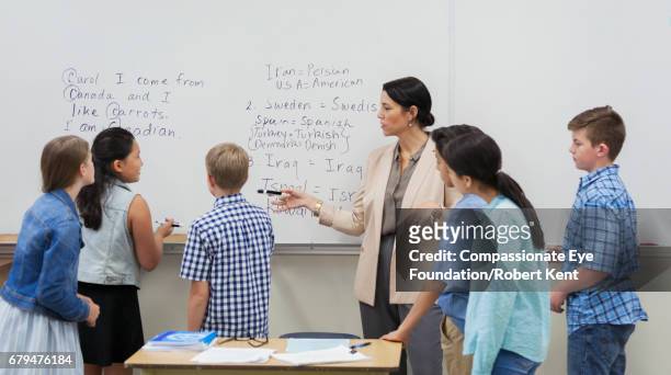 teacher and students using white board in classroom - english language bildbanksfoton och bilder