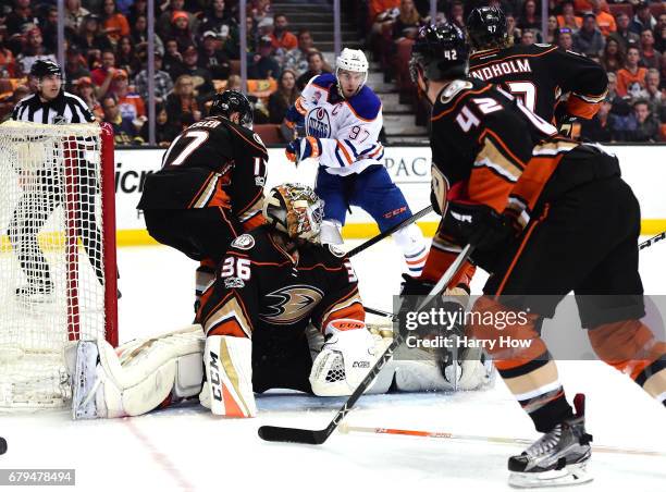 Connor McDavid of the Edmonton Oilers bats the puck out of the air to score a power-play goal past John Gibson and Ryan Kesler of the Anaheim Ducks,...