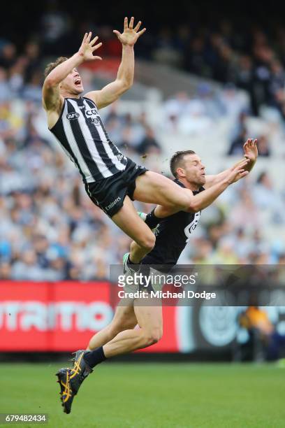 Taylor Adams of the Magpies marks the ball high over Sam Docherty of the Blues during the round seven AFL match between the Collingwood Magpies and...