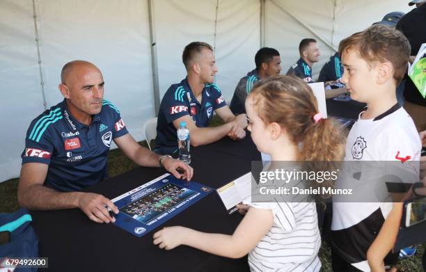 Coach Kevin Muscat signs autographs during a Melbourne Victory A-League media opportunity at The Entertainment Quarter on May 6, 2017 in Sydney,...