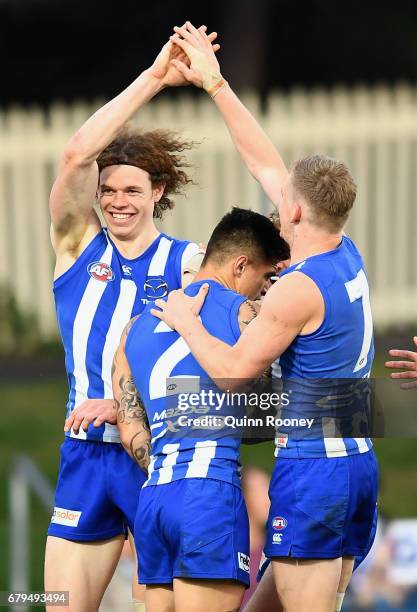 Ben Brown of the Kangaroos is congratulated by team mates after kicking a goal during the round seven AFL match between the North Melbourne Kangaroos...