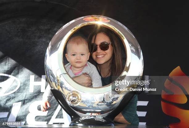 Woman with her child poses for a picture with the A-League trophy during a Sydney FC A-League media opportunity at The Entertainment Quarter on May...