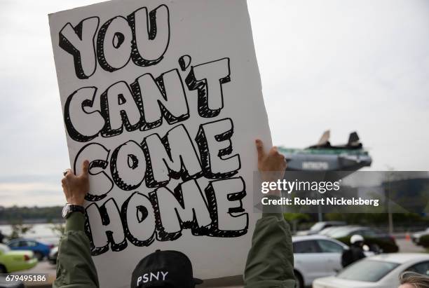 Protesters gather before the arrival of the motorcade carrying President Donald Trump near the USS Intrepid where the President is scheduled to host...