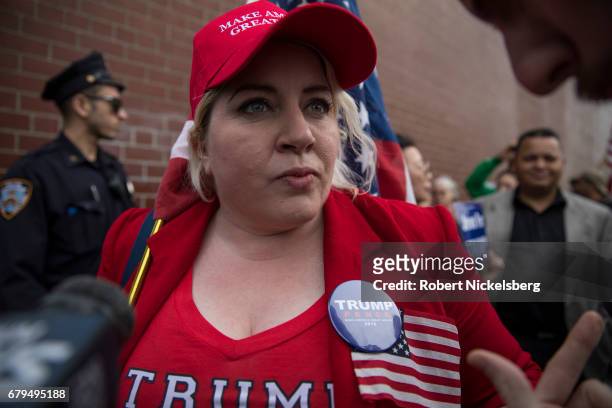 Supporter of President Donald Trump, Diane Atkins from Brooklyn, New York, speaks with media before the arrival of the motorcade carrying President...
