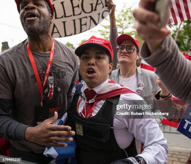 Supporters of President Donald Trump argue with protesters before the arrival of the motorcade carrying President Donald Trump near the USS Intrepid...