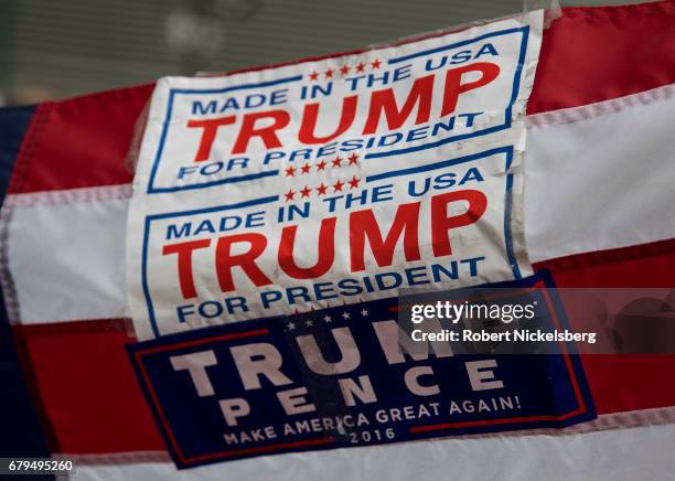 Pro-Trump sign is held up by supporters of President Donald Trump before the arrival of the motorcade carrying President Donald Trump near the USS...