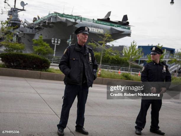 Members of the New York Police Department keep protesters behind barricades during the arrival of the motorcade carrying President Donald Trump near...