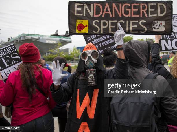 Protesters demonstrate during the arrival of the motorcade carrying President Donald Trump near the USS Intrepid where the President is scheduled to...
