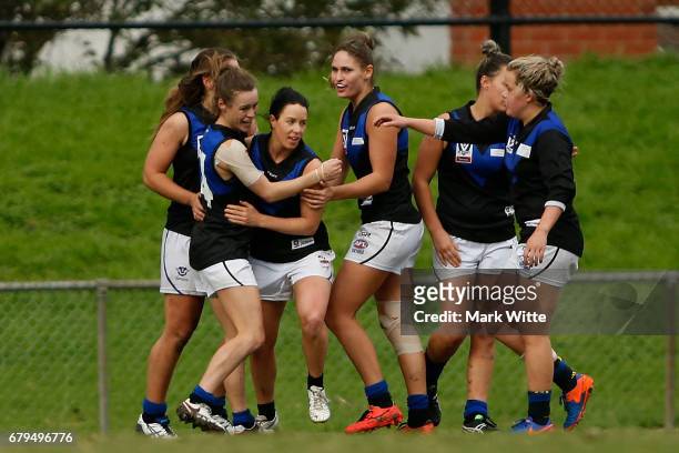 Melbourne Uni celebrate one of there goals during the round one VFL Women's match between the Darebin Falcons and Melbourne Uni at Bill Lawry on May...