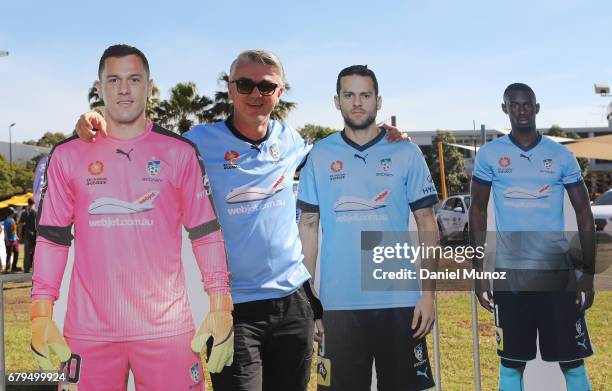 Fan poses with pictures of goalkeeper Danny Vukovic and striker Bobo during a Sydney FC A-League media opportunity at The Entertainment Quarter on...