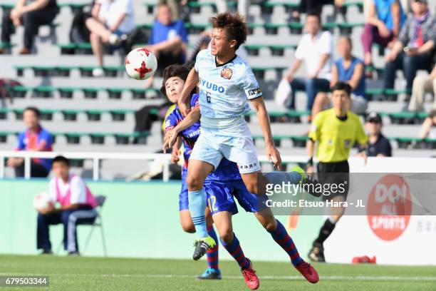 Keisuke Tanabe of FC Ryukyu controls the ball under pressure of Mao Kobayashi of FC Tokyo during the J.League J3 match between FC Tokyo U-23 and FC...