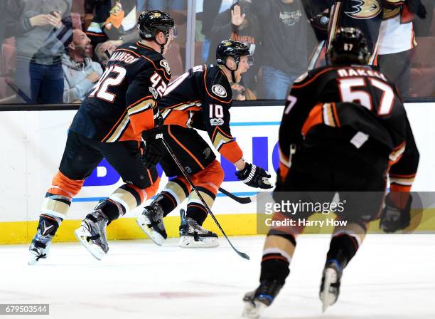 Corey Perry of the Anaheim Ducks celebrates his goal for a 4-3 win over the Edmonton Oilers with Josh Manson and Rickard Rakell during the second...