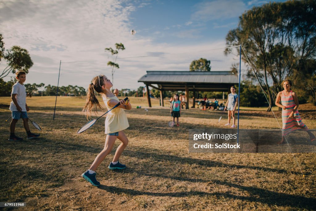 Group of Children Playing Badminton in the Park