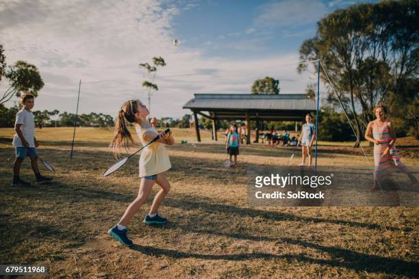 group of children playing badminton in the park - kids event stock pictures, royalty-free photos & images