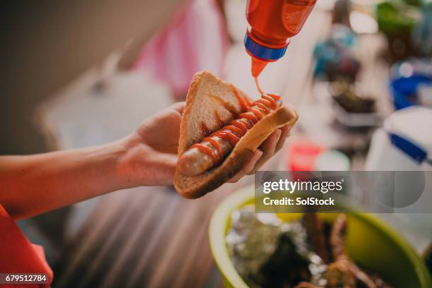 delicious sausage sizzle - tomato sauce stock pictures, royalty-free photos & images