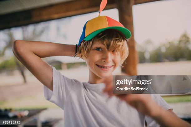 portrait of young boy wearing a propeller hat - boys with braces stock pictures, royalty-free photos & images