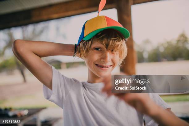 portrait of young boy wearing a propeller hat - blonde boy braces stock pictures, royalty-free photos & images