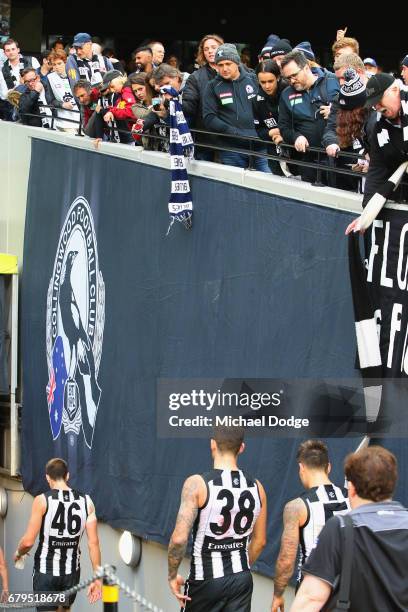 Blues fan dangles a Blues scarf down at dejected Magpies players during the round seven AFL match between the Collingwood Magpies and the Carlton...