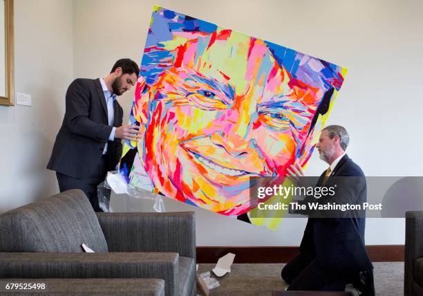 Lynchburg, VA President of Liberty University, Jerry Falwell Jr. And his son Trey unwrap a portrait of Donald Trump gifted by a university donor, in...
