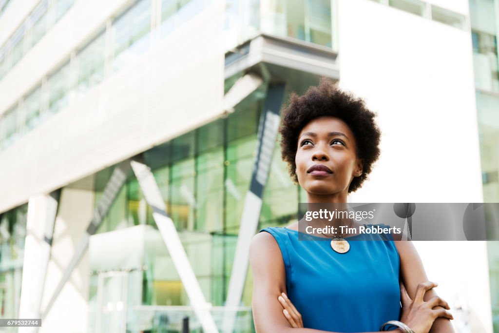 Woman looking up with arms crossed