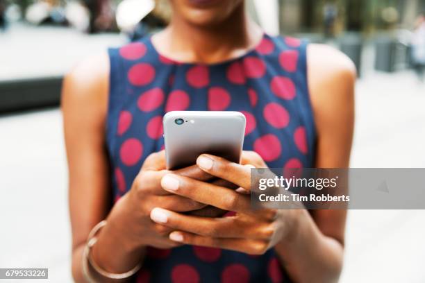 closer up of woman using smart phone - one young woman only texting foto e immagini stock