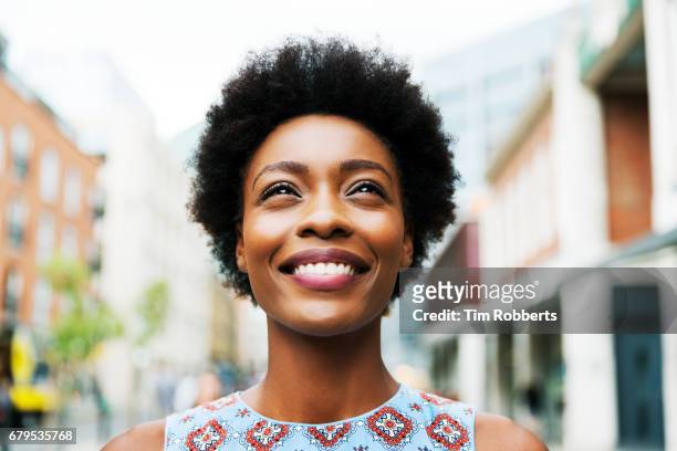 woman looking up - afro hairstyle stock pictures, royalty-free photos & images