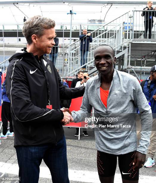 Nike President and CEO Mark Parker shakes hand with Eliud Kipchoge at on the arrive during the Nike Breaking2: Sub-Two Marathon Attempt at Autodromo...