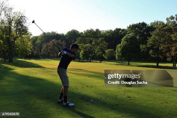 youth golfer practices his swing at a public park - bad golf swing stock pictures, royalty-free photos & images