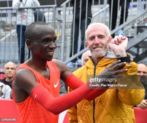 Eliud Kipchoge shows Sandy Bodecker's tattoo at the finish area during the Nike Breaking2: Sub-Two Marathon Attempt at Autodromo di Monza on May 6,...