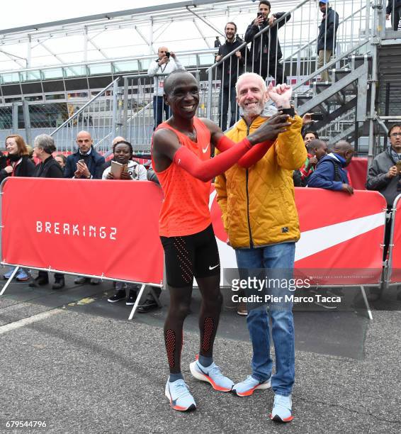 Eliud Kipchoge shows Sandy Bodecker's tattoo at the finish area during the Nike Breaking2: Sub-Two Marathon Attempt at Autodromo di Monza on May 6,...