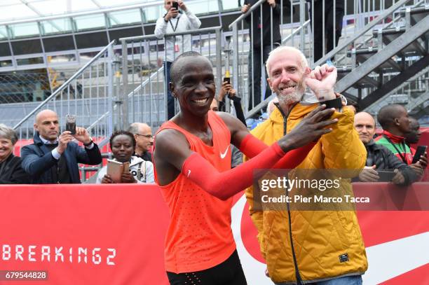 Eliud Kipchoge shows Sandy Bodecker's tattoo at the finish area during the Nike Breaking2: Sub-Two Marathon Attempt at Autodromo di Monza on May 6,...