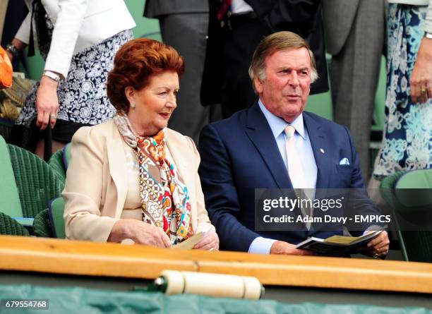 Sir Terry Wogan and his wife Lady Helen watch the action between Spain's Rafael Nadal and USA's Michael Russell during day one of the 2011 Wimbledon...