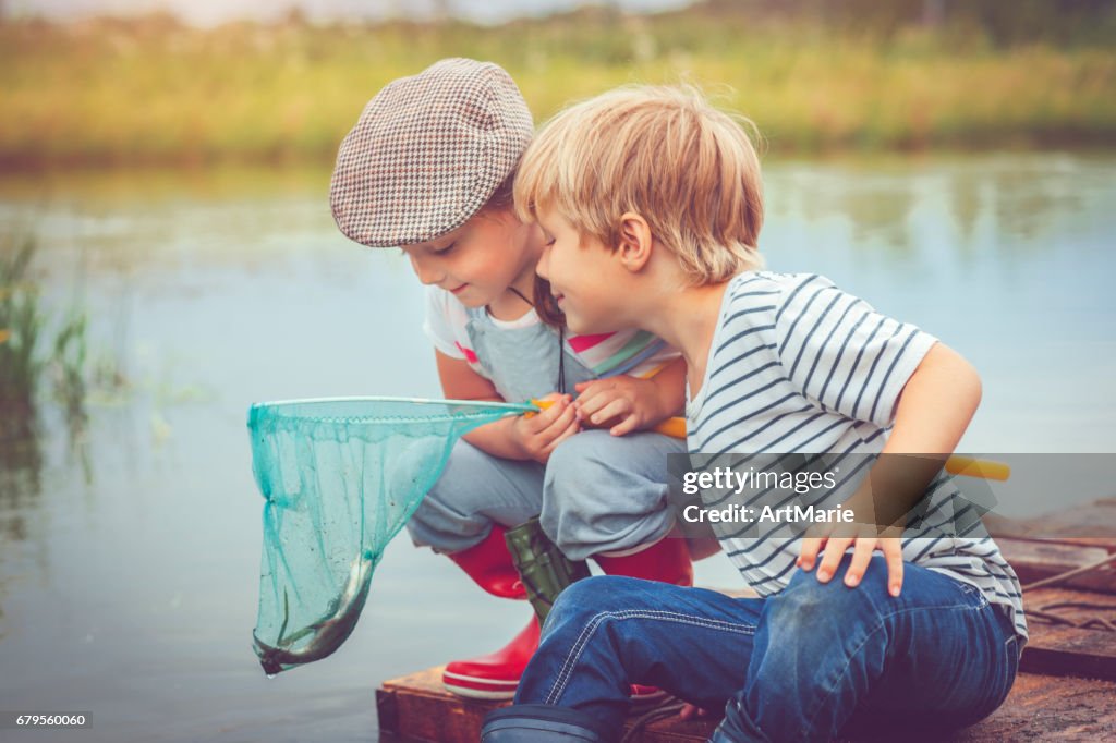 Children traveling on raft and fishing