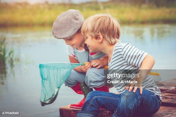 children traveling on raft and fishing - kids at river stock pictures, royalty-free photos & images