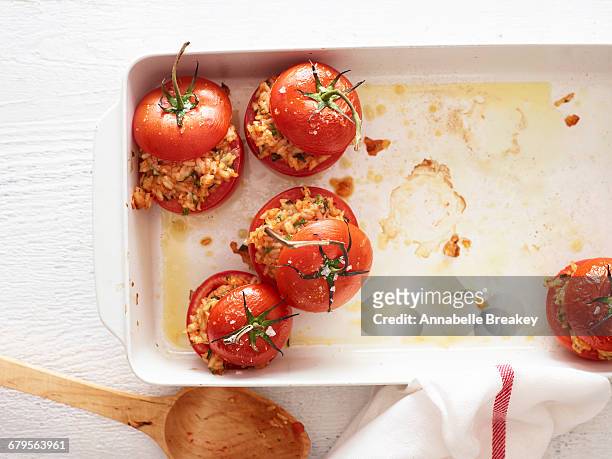 overhead of tomatos stuffed with risoto on white - risoto foto e immagini stock