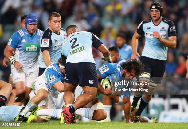 Akira Ioane of the Blues is tackled during the round 11 Super Rugby match between the Waratahs and the Blues at Allianz Stadium on May 6, 2017 in...