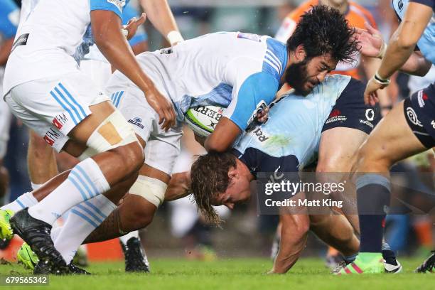 Akira Ioane of the Blues is tackled by Michael Hooper of the Waratahs during the round 11 Super Rugby match between the Waratahs and the Blues at...