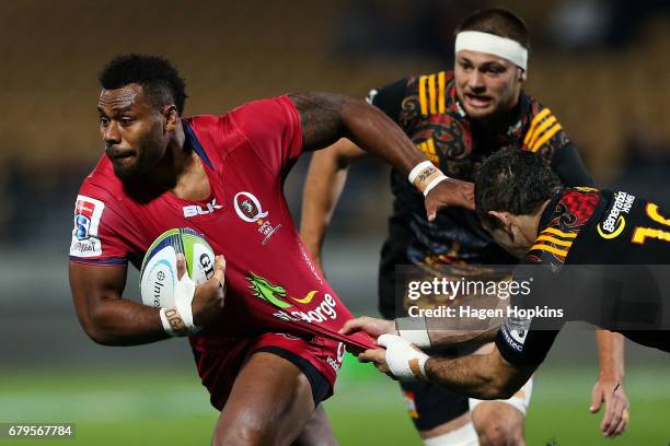 Samu Kerevi of the Reds is tackled by Stephen Donald of the Chiefs during the round 11 Super Rugby match between the Chiefs and the Reds at Yarrow...