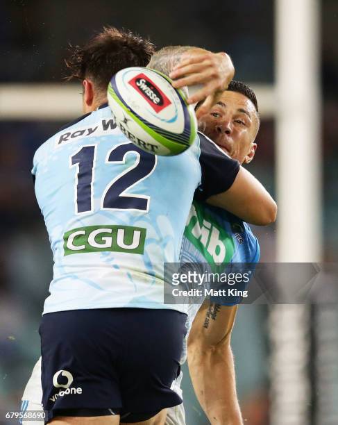 Sonny Bill Williams of the Blues offloads the ball in a tackle during the round 11 Super Rugby match between the Waratahs and the Blues at Allianz...