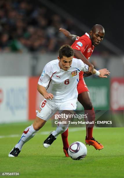 Czech Republic's Lukas Vacha attempts to hold off Switzerland's Innocent Emeghara