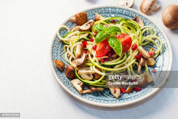 delicious zoodles with mushrooms and pomegranate seed - low carb diet stock pictures, royalty-free photos & images