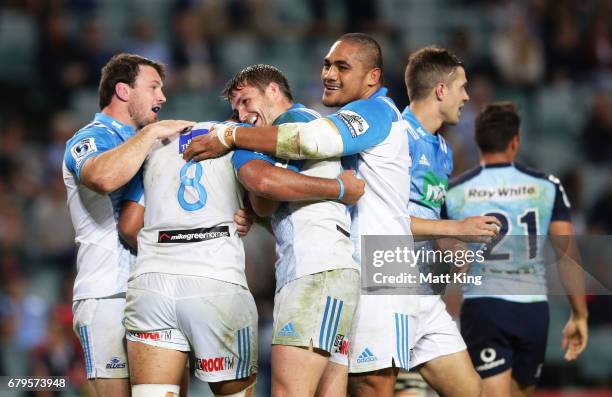 Akira Ioane of the Blues celebrates with team mates after scoring a try during the round 11 Super Rugby match between the Waratahs and the Blues at...